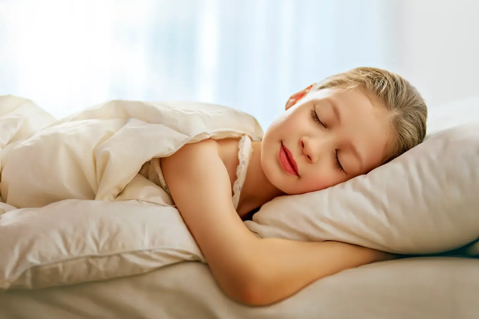 Child sleeping peacefully in a bright bedroom