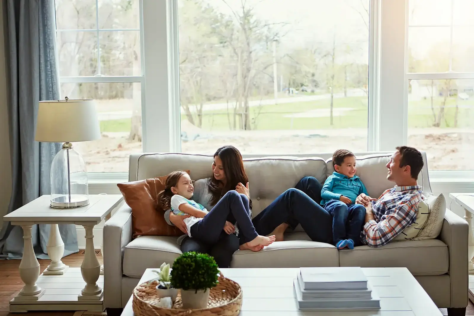 Family relaxing together in a bright, clean living room in a Metro Detroit home