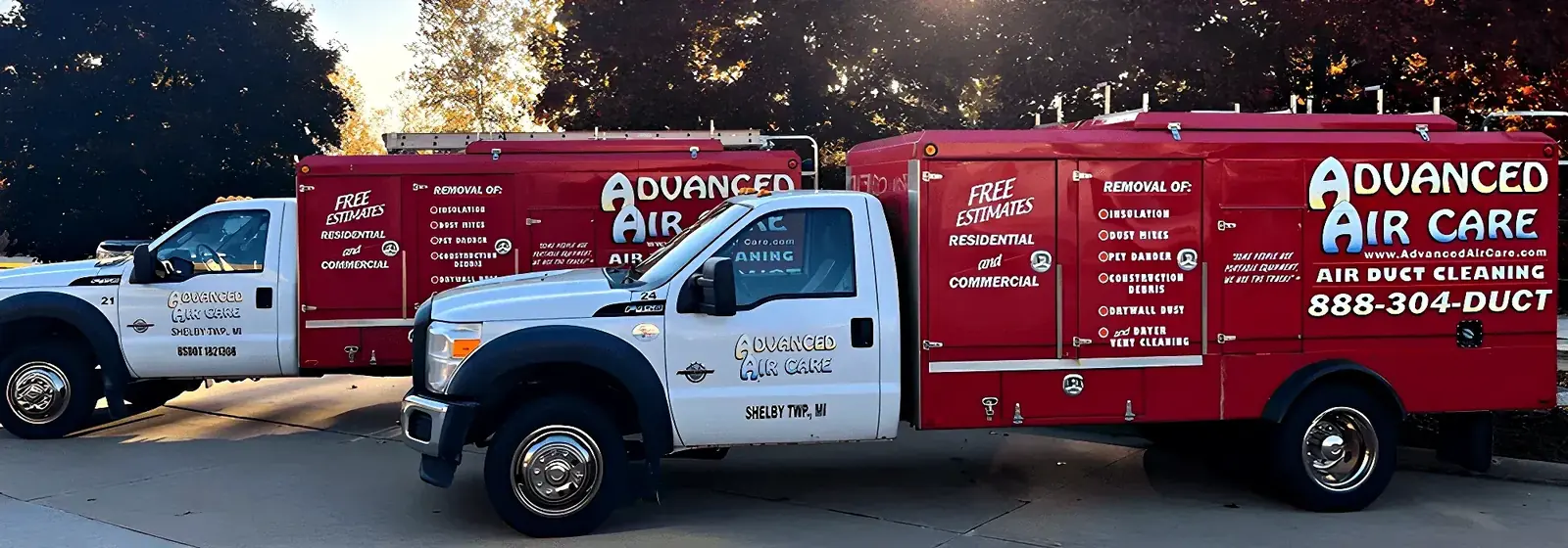 Two Advanced Air Care trucks on a Macomb County job